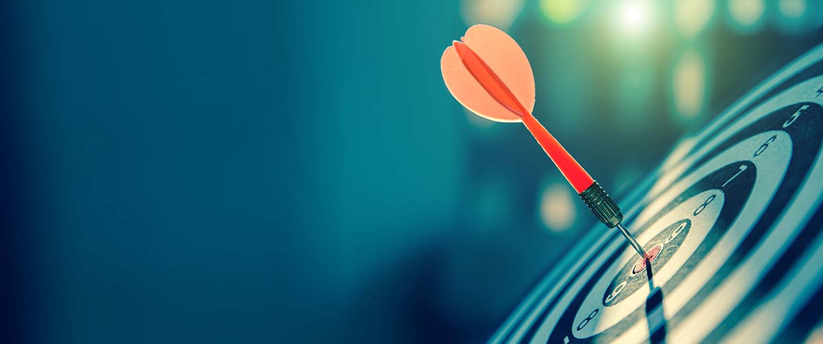 Red dart hitting the bullseye on a dartboard, metaphor for targeted digital marketing.