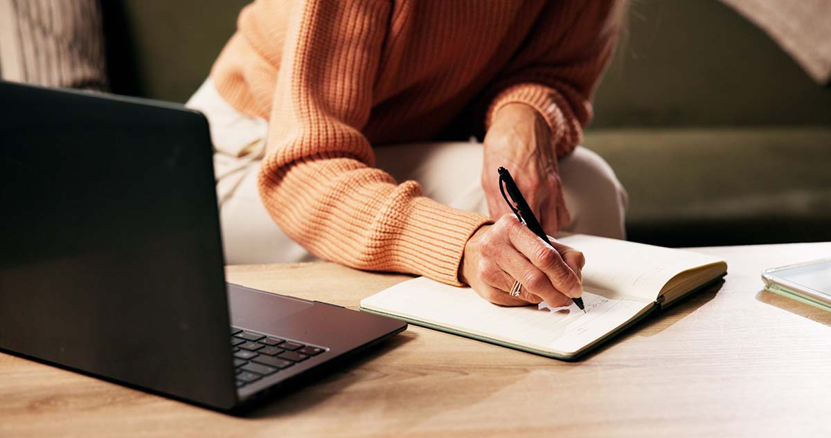 Entrepreneur reviewing plans and using small business resources to make better website decisions