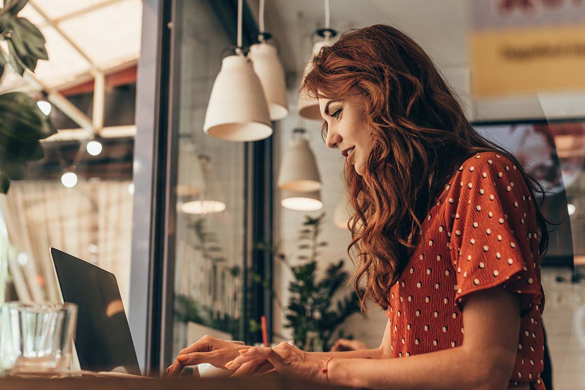 Small business owner working on a laptop, representing thoughtful blog content creation and ongoing SEO work.