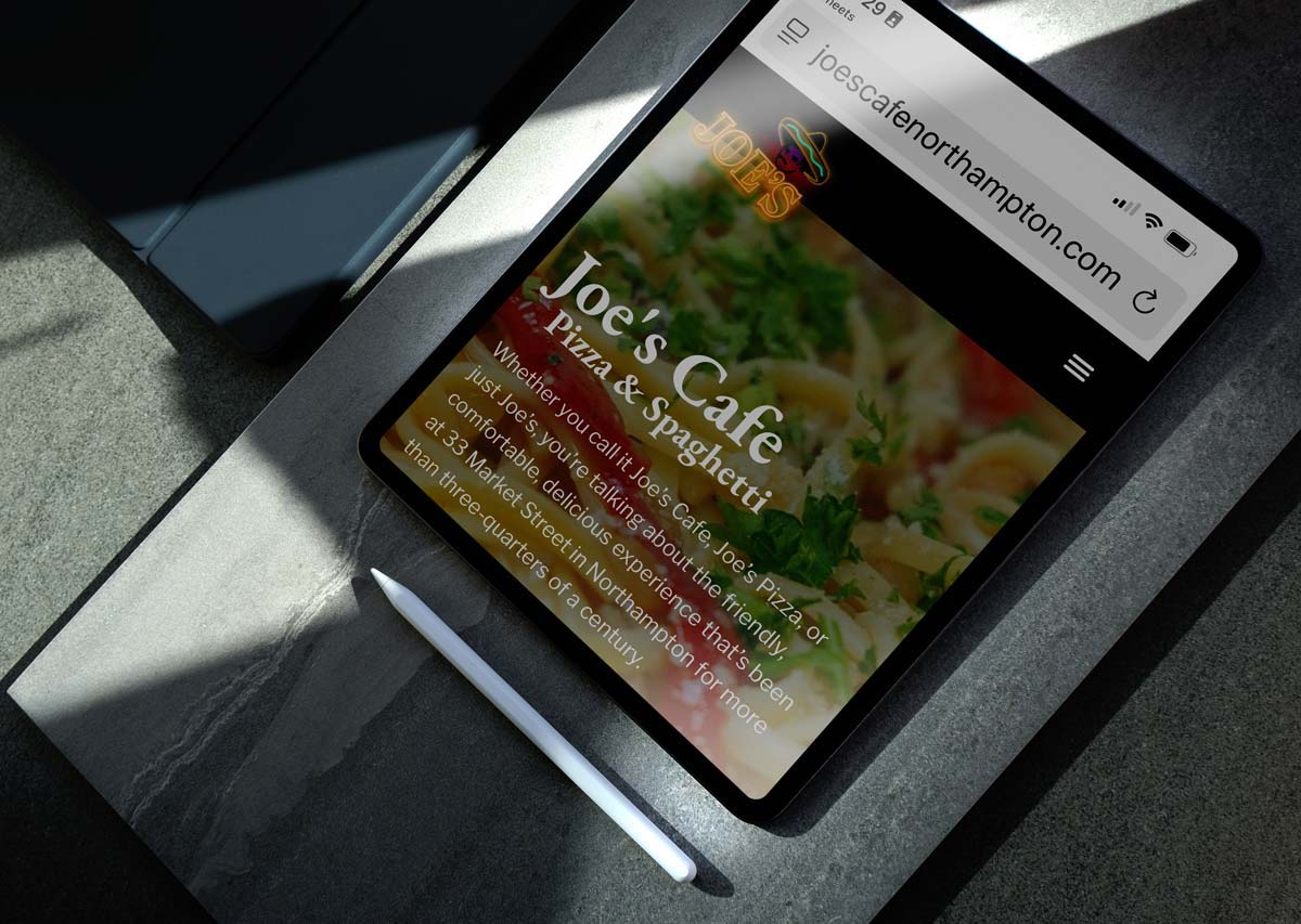 Tablet displaying a restaurant website as an example of a working business tool
