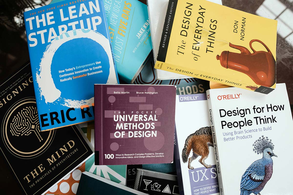 Stack of business and design books suggesting DIY small business web design in Western Massachusetts