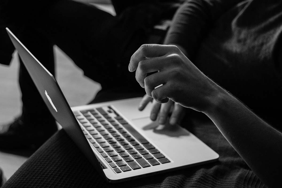 Person working on a MacBook, learning Springfield, MA SEO for a local WordPress site