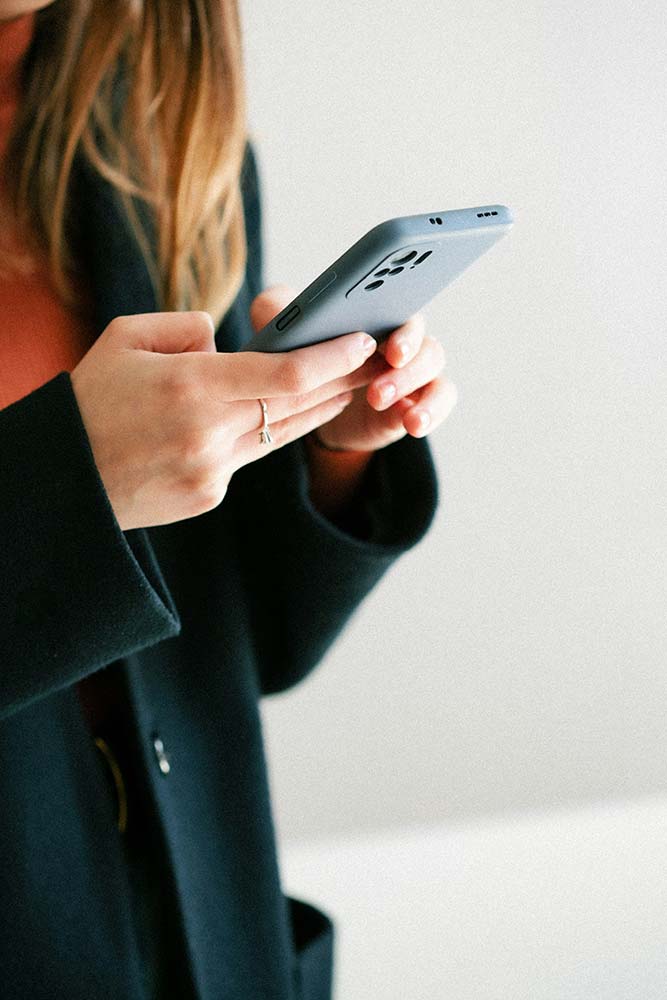 woman surfing the web on her iPhone