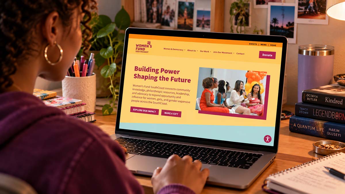 Women’s Fund SouthCoast website displayed on a laptop in a home workspace.