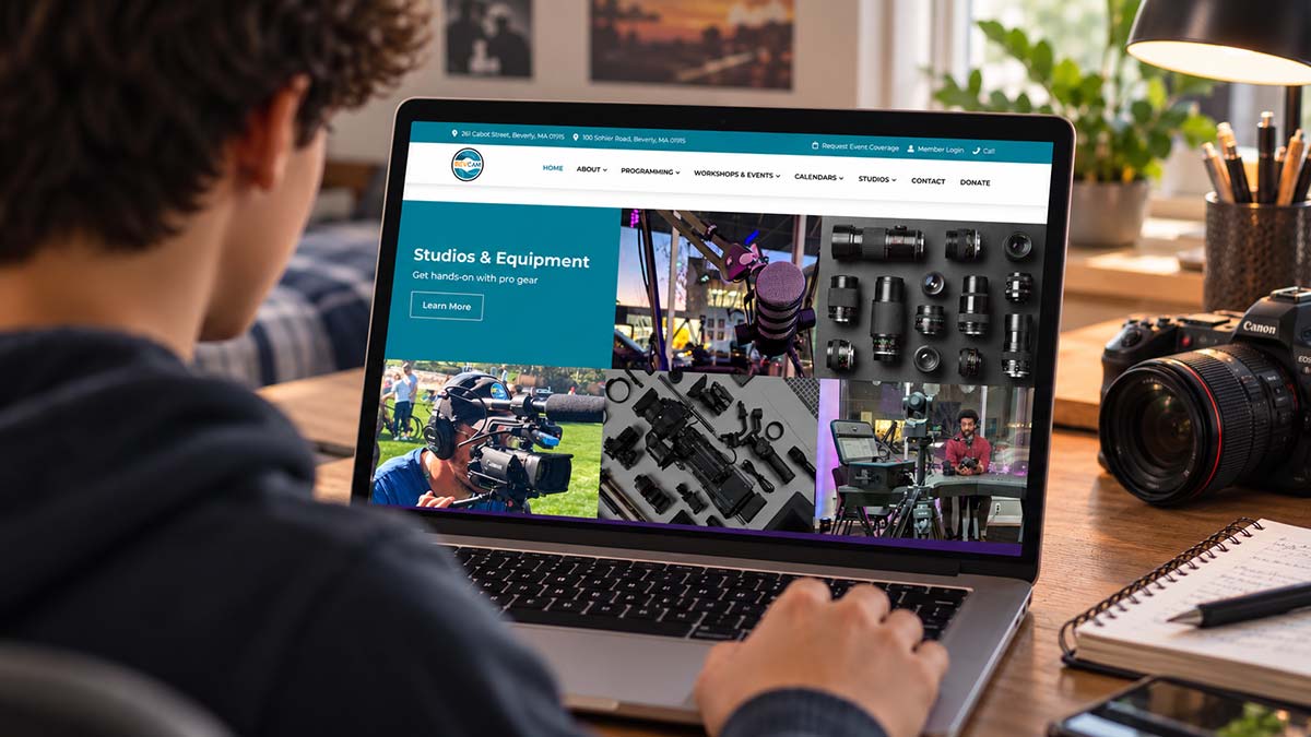 BevCam community media website displayed on a laptop beside professional camera equipment.
