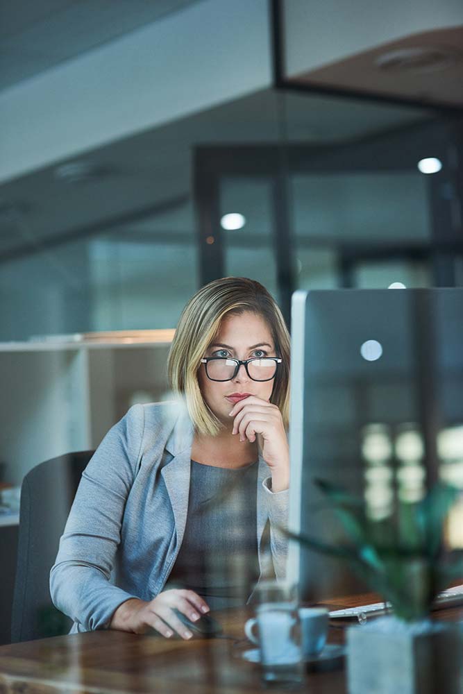 A woman at her desk reviewing technical SEO on her website
