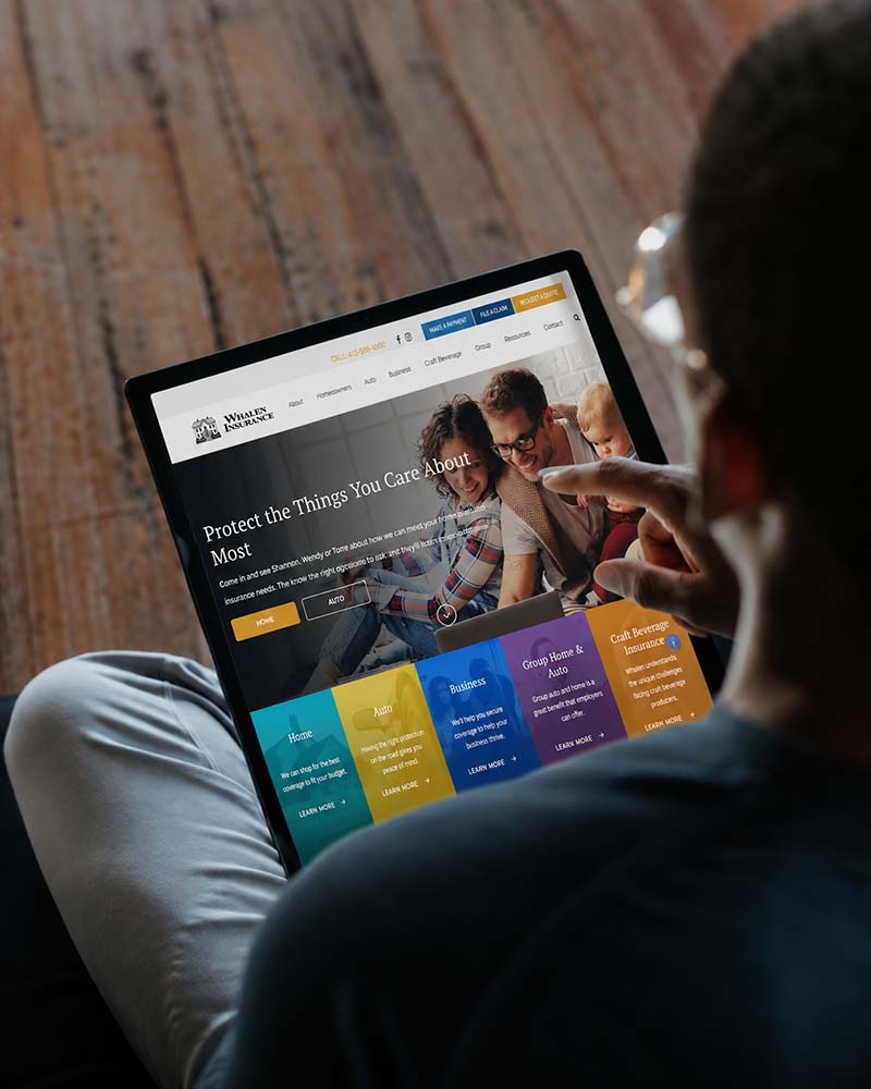 man browsing professional service website Whalen Insurance
